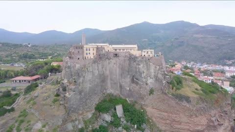 aerial view of the fort of san giorgio located on a hill near the port of the island of capraia