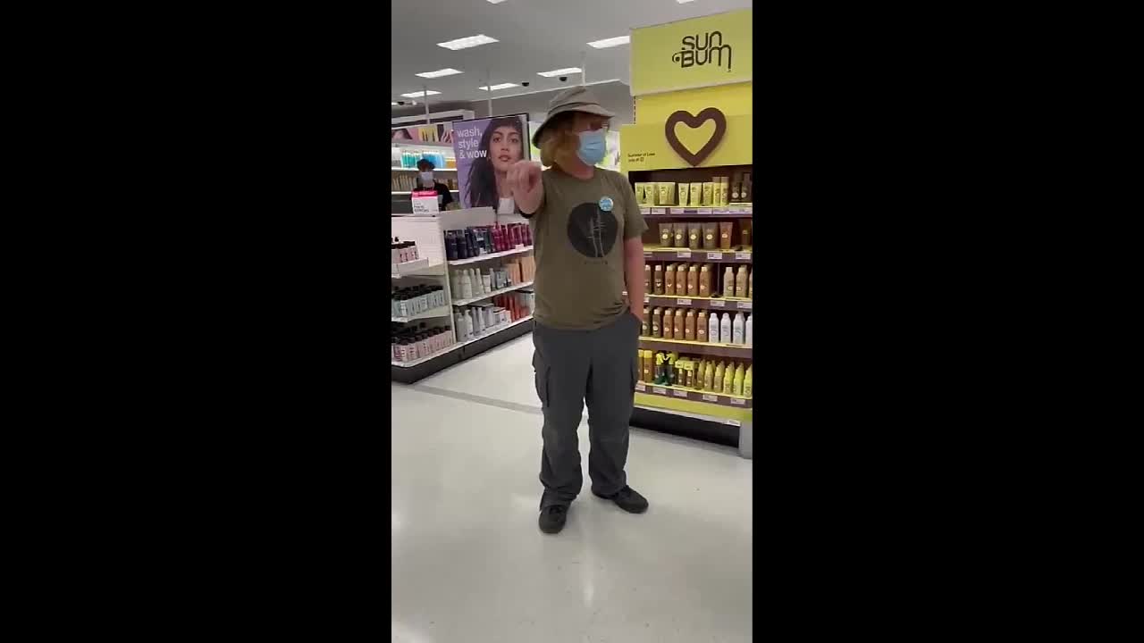Man With "Vaccinated" Badge Follows Woman Around Store To Put Her Mask On