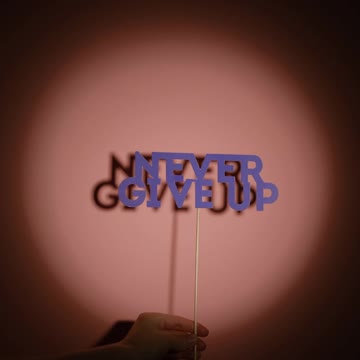 Crop Person Waving Sign in Spotlight