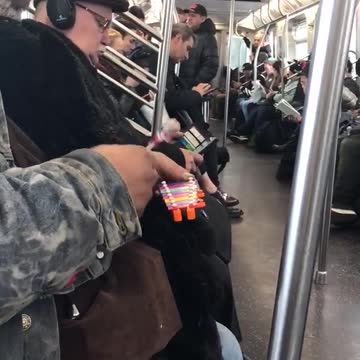 Big man on subway plays tiny xylophone