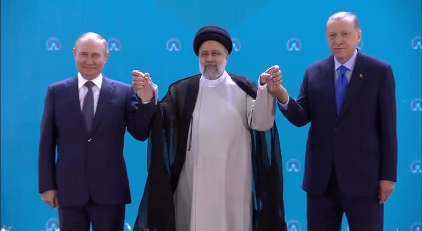 Putin, Raisi, and Erdogan holding hands in Iran.