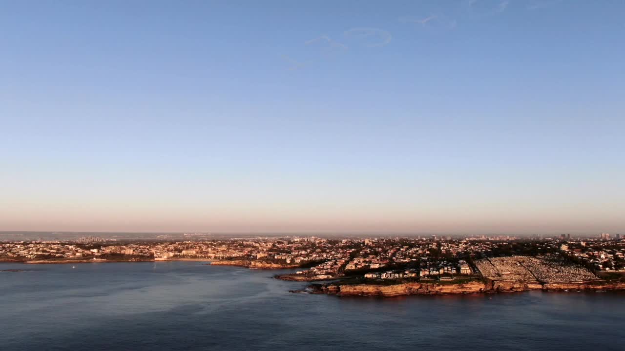 Drone view of Sydney cityscape at sunrise on ANZAC day 2020 showing the words Lest We Forget