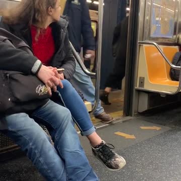 Man brown jacket signing subway doors open