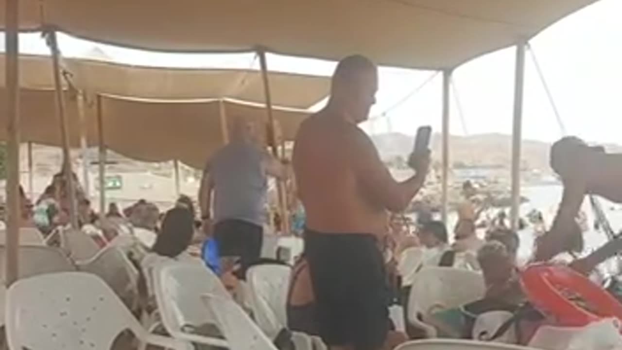 People at the beach in Eilat are celebrating the rescue of the hostage upon after