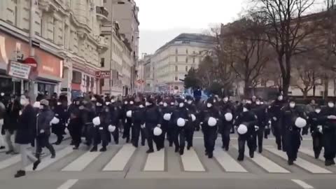 Police walking in solidarity with protestors in Austria