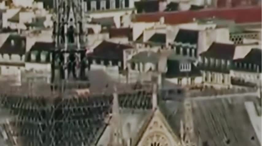 Black Clad Figure on Notre Dame roof lighting devices minutes before fire