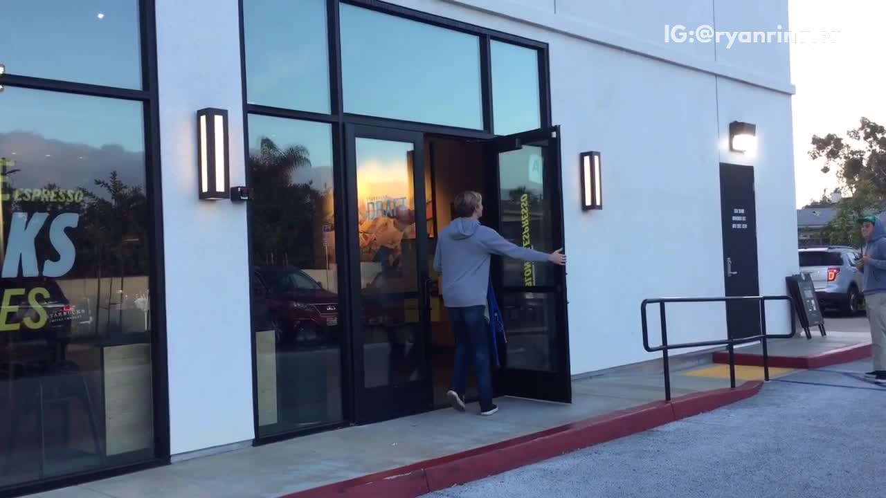 Guy walks into store and comes out in blue wetsuit