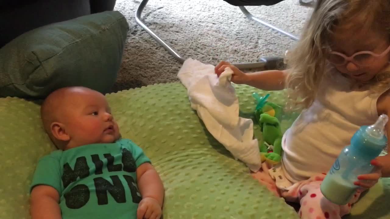 Big sister helps out her baby brother