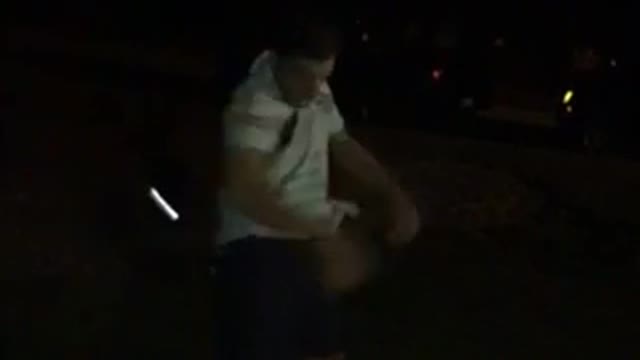 Guitar spin at night lands on grass