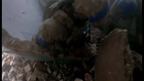 Ukrainian Soldiers Trying to Free Another's Leg Caught Under Rubble