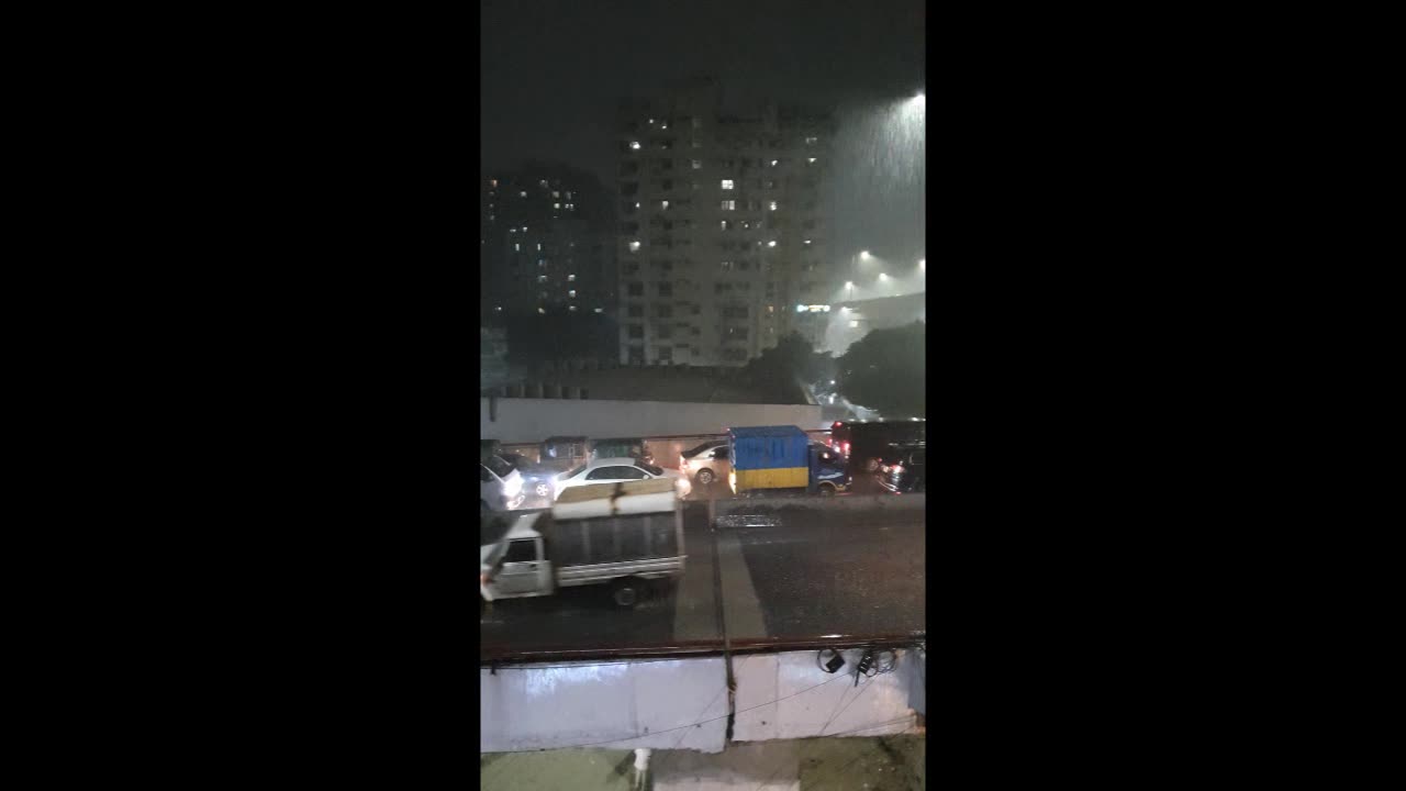 Heavy rain fall in city at night