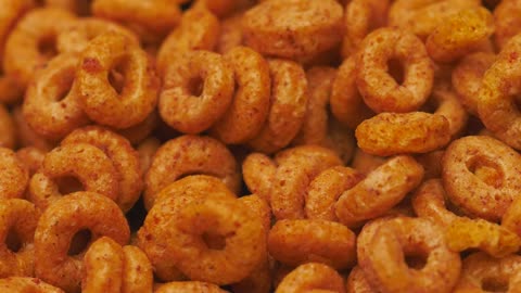 Cereal texture of oatmeal and cinnamon rings, rotating