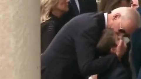 Joe Biden kissing and rubbing children