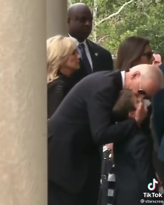 Joe Biden kissing and rubbing children