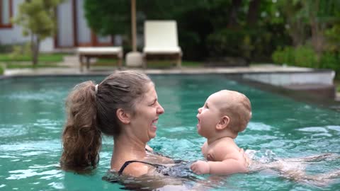 Mother Playing With Her Child In The Pool