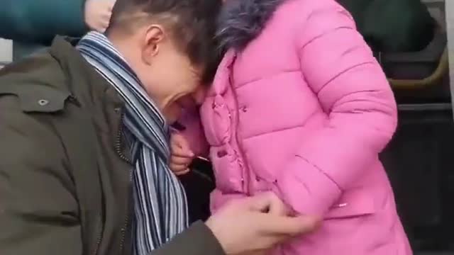 Ukrainian father saying goodbye to his daughter to engage in battle with Russia