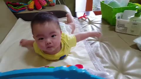 Superman baby playing the piano