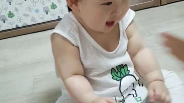 This is a video of a baby clapping and having fun.