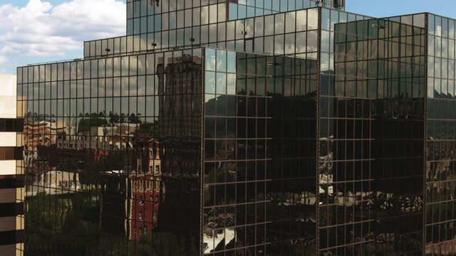 The exterior of the building reflects the building and the distant view