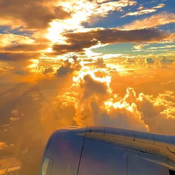 A plane flying above the clouds in a mesmerizing sunset view