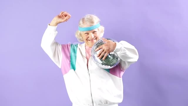 joyful aged woman portrait holding mirrorball