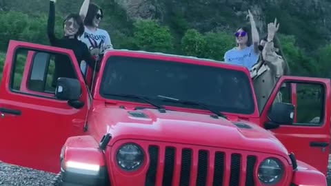 A group of friends dancing in the car