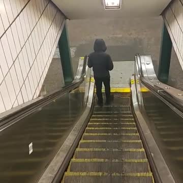 Man walking on escalator going backwards
