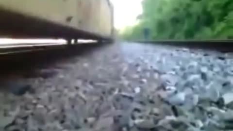 Dude stuck under a moving train escapes between its rails 😳