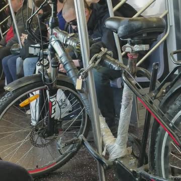 Bike chained onto pole on subway