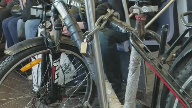 Bike chained onto pole on subway