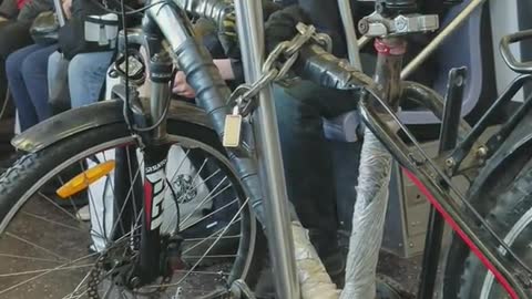 Bike chained onto pole on subway