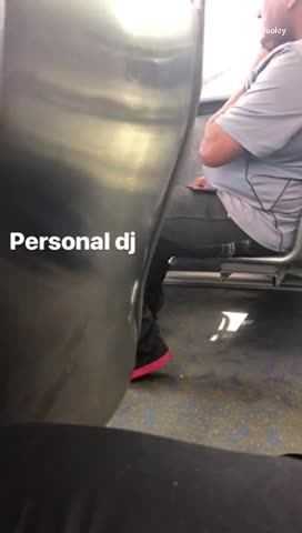Personal dj man plays music out of his phone on bus