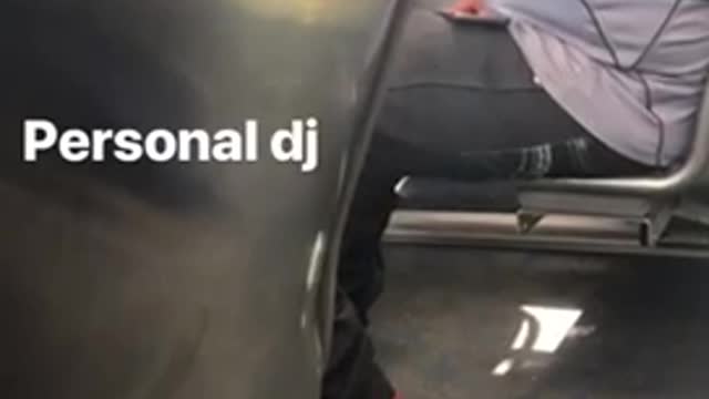 Personal dj man plays music out of his phone on bus