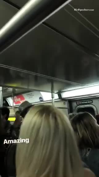 Group of people on subway sing lean on me
