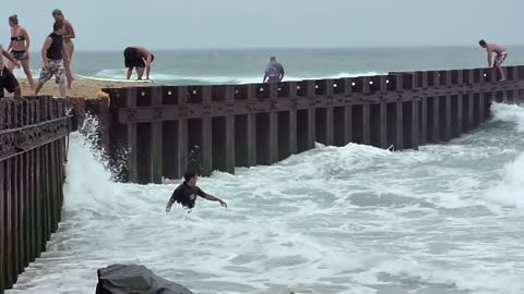 Some guy learning to surf on the wrong day