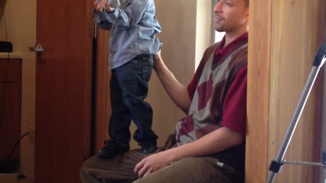 Kid Pretends To Talk Like A Preacher Into A Microphone