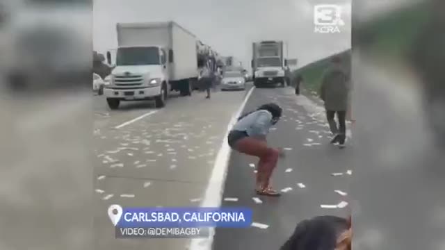 A highway in Santiago littered with $1 bills