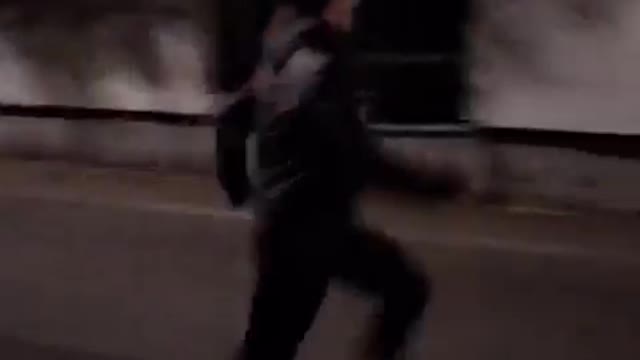 Black hoodie guy runs at white wall