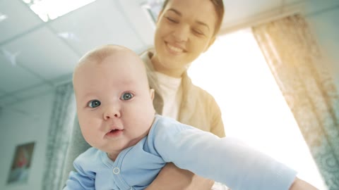 Very happy mother holding her baby