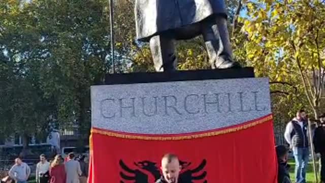 Albanians have draped an Albanian flag around the Churchill monument at Whitehall