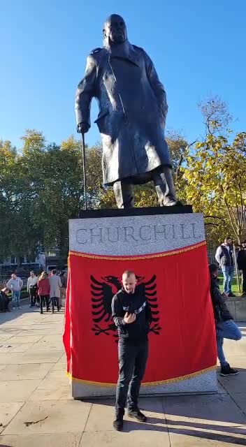 Albanians have draped an Albanian flag around the Churchill monument at Whitehall