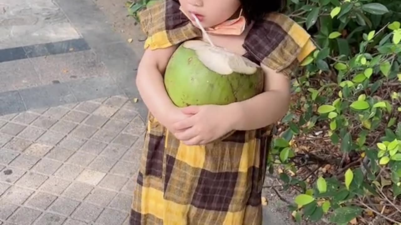 Super cute baby drinking coconut water