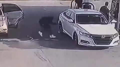 Thieves steal a guy's car while he pumps gas