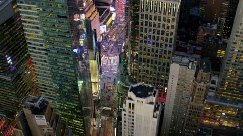 Skyscrapers and digital billboards shine in a city at night