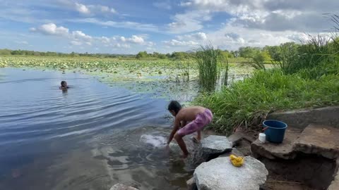 Laundry in Sri Lanka. Mother teaches daughter