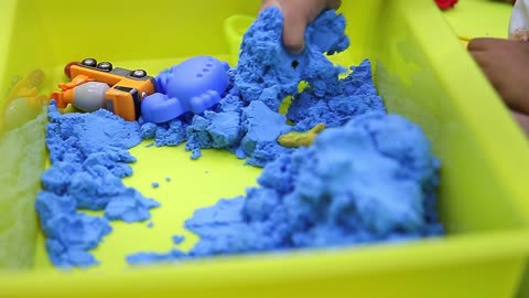 Child's Hand Playing Toy Sand at Home