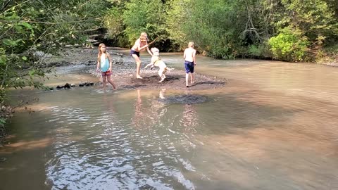 Rico with the kids in the creek