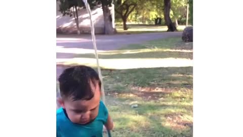 Child enjoying watering lawn