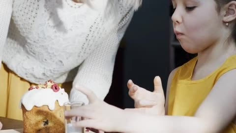 Mother traning little girl cooking