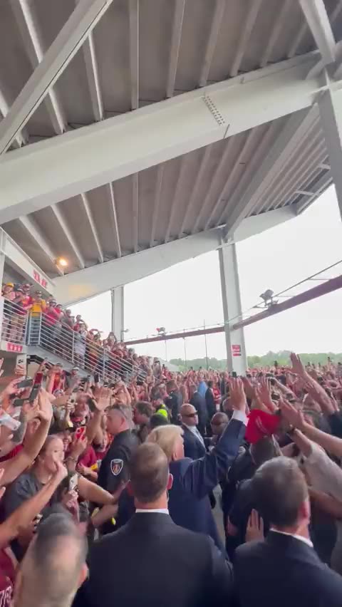 A huge crowd warmly welcomes Trump at an Iowa college football game.